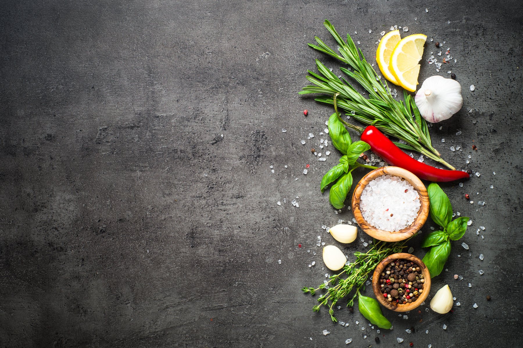 Selection of Spices and Herbs  on Dark Stone Table.